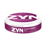 ZYN Black Cherry Mini Dry 6mg nicotine pouches presented in a sleek purple and white can with a strength level of 4 out of 4 dots. Offers a bold and luscious black cherry flavour in a compact and discreet format, facing down showing the rims of the can
